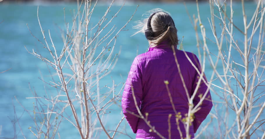 Retired senior woman looking at river moving past her in Zion Utah. Close up of mature nature lover watching water flow by from the river