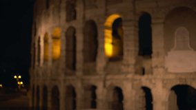 Out of focus background plate of ancient building facade of arches in Rome Italy. Close up view of Roman Colosseum at night in an ancient city in Europe