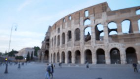 Out of focus background plate of ancient coliseum in Europe in the late afternoon. Exterior view of blurred Roman Colosseum with tourists walking nearby in Rome Italy