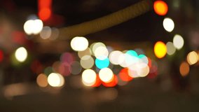 Blurry background plate of city traffic at night with bokeh headlights passing by. Defocused Video backdrop for green screen compositing. 4k