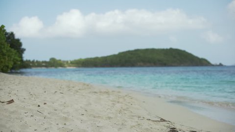 Sand-level shot of the Caribbean shoreline for green screen or chroma key. Out of focus or defocused background plate for compositing or keying.