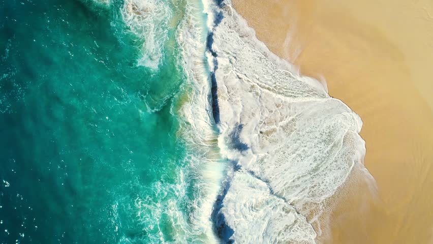 Aerial view waves break on white sand beach. Sea waves on the beautiful beach. drone 4k shot. zoom in	 Royalty-Free Stock Footage #1015024837