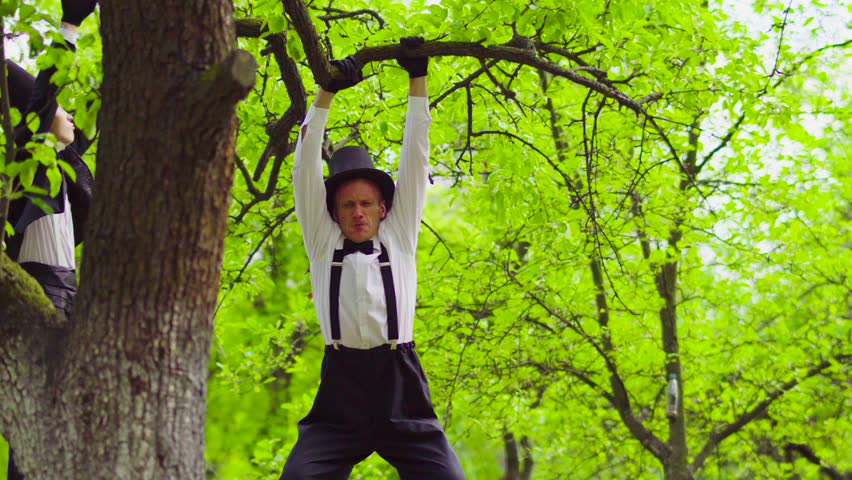 Street actor pulls up on a branch
