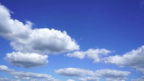 Beautiful bright blue cloudy sky background. White fluffy clouds slowly moving and real romantic cloud in shape of heart appears in sky. Timelapse. Slow motion video footage.