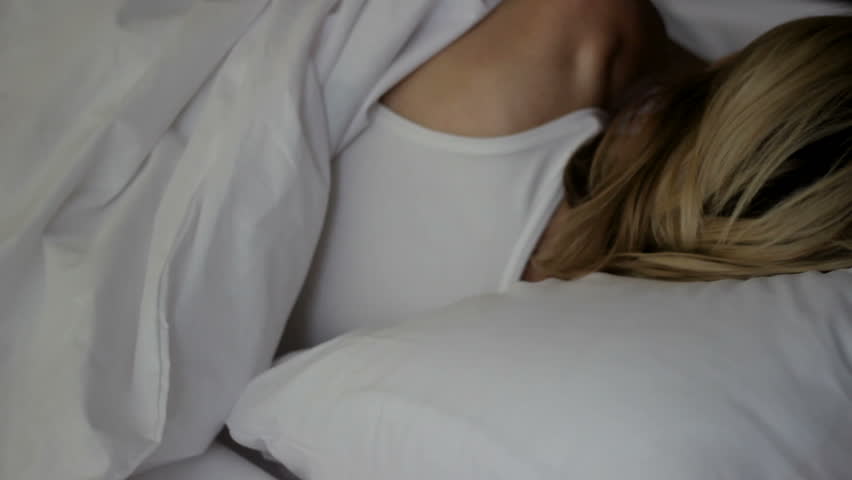 Female trying to doze off menstruation day, turning to sides can not fall asleep Royalty-Free Stock Footage #1015039858
