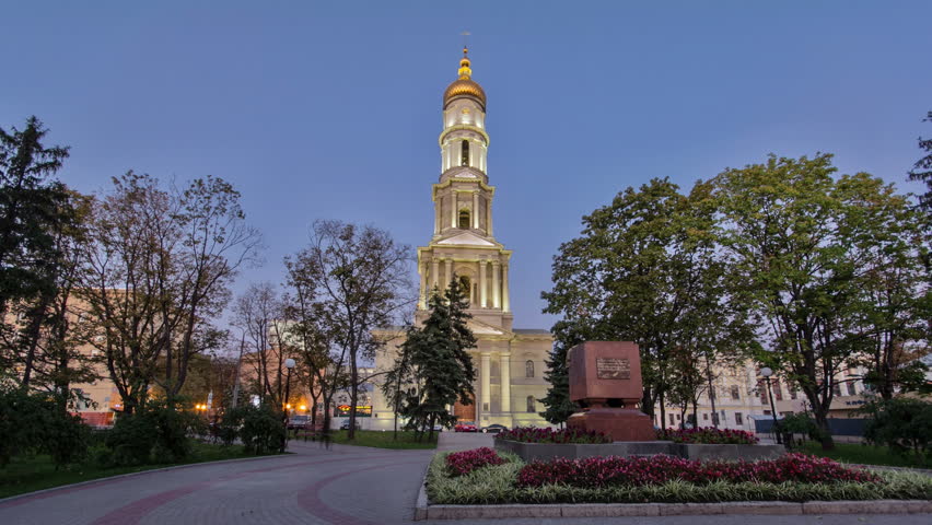 The bell tower of the Assumption Cathedral (Uspenskiy Sobor) day to night timelapse, philharmonic organ hall after sunset in Kharkiv, Ukraine
