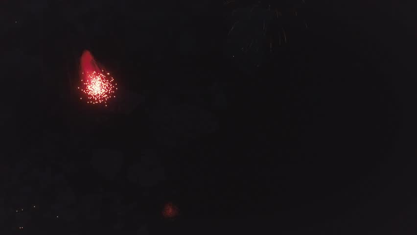 Aerial: Firework show above glacier lagoon. Pyrotechnic launched from icebergs remotely  Iceland