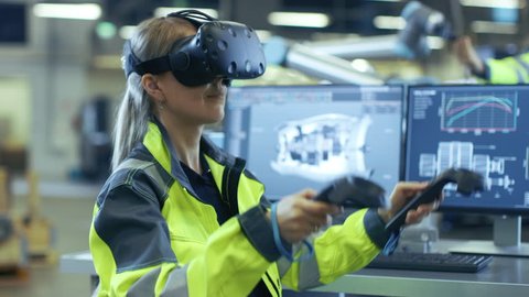 Female Industrial Engineer Wearing Virtual Reality Headset and Holding Controllers, She Uses VR technology for Industrial Design, Development and Prototyping in CAD Software.