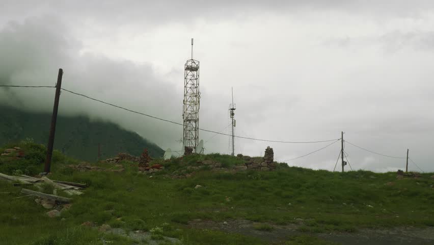 View of cell tower set using old stones high in Ossetian mountains