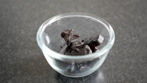 Tasty Liquorice Candy falls into a glass bowl