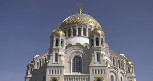 4K video footage of beautiful Nikolskiy Navy Cathedral taken from Anchor Square, area around it in the heart of Kronstadt town near St Petersburg 700 km from Moscow, Russia on sunny summer afternoon