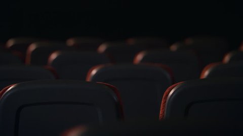 Empty comfortable seats in cinema. Empty seats in movie theatre. Back view of armchairs in empty hall of cinema. Cinema hall is ready for visitors. Cinema chair back view