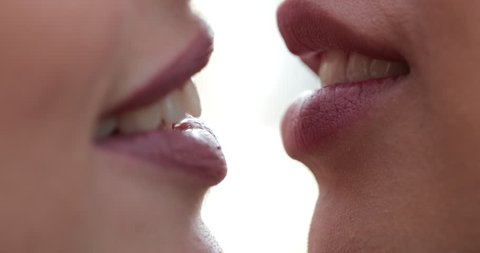 Extreme close-up of lesbian LGBT french kiss