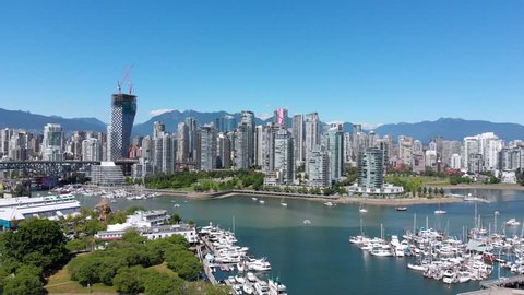 Vancouver, British Columbia, Canada, aerial view of False Creek and Downtown buildings by day during summer.