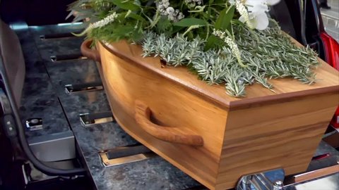closeup shot of a funeral casket in a hearse 

