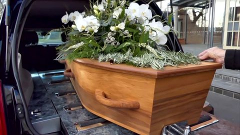 closeup shot of a funeral casket in a hearse 