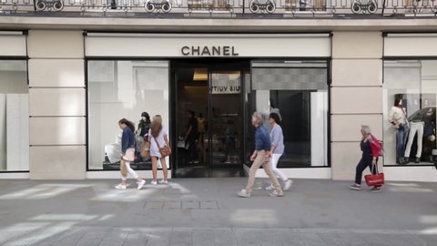 LONDON, UK - August 15th, 2018: A front exterior view of Chanel store on New Bond Street, in Mayfair. Crowds of tourists and locals with shopping bags passing by. 