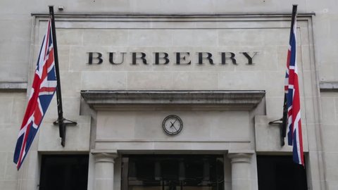 LONDON, UK - AUGUST 15, 2018: A view of British Burberry fashion shop on Bond Street, Mayfair in London. A high end British brand selling expensive luxury fashion items. UK flags next to the logo. 