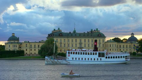 Drottningholm, Sweden - AUGUST 15, 2018: Steamboat and rowboat by Drottningholm Palace.