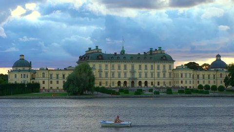 Drottningholm, Sweden - AUGUST 15, 2018: A man in a rowboat by Drottningholm Palace, Stockholm, Sweden. 