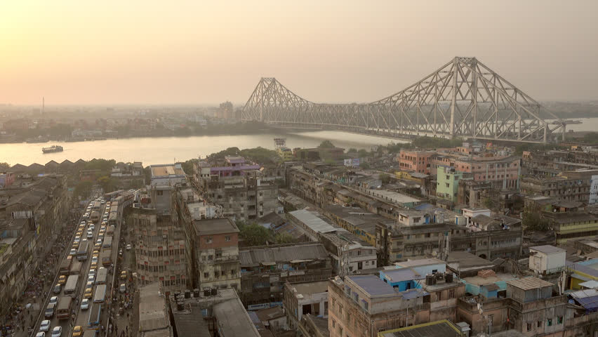 Beautiful sunset view of Kolkata city with a Howrah bridge on the Ganga river, West Bengal, India. Royalty-Free Stock Footage #1015088083