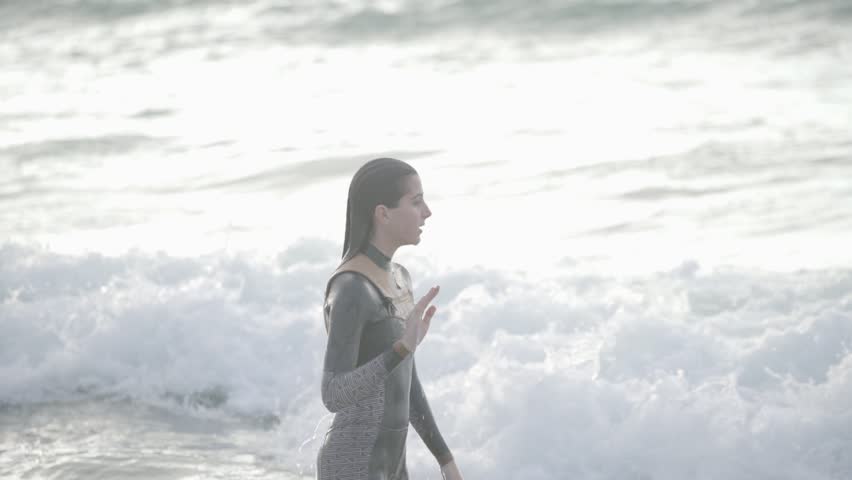 Pretty girl with surfboard on beach.
