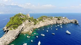 Aerial cinematic video flying over coastline with parked boats Amalfi coast positano in Italy