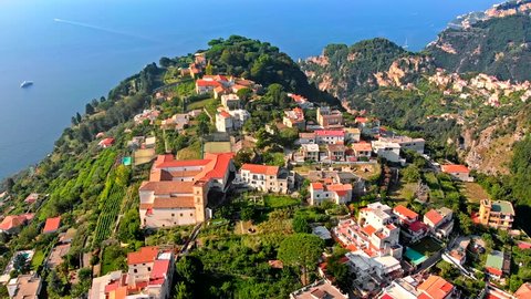 Aerial drone flying forward in ravello village on top of hill in the positano region of Italy showing a small hilltop village 