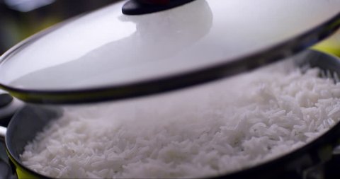 White steamed rice with lid coming off the container | Delicious looking  cooked rice