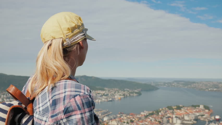 A woman tourist admires a beautiful view of the city of Bergen in Norway
