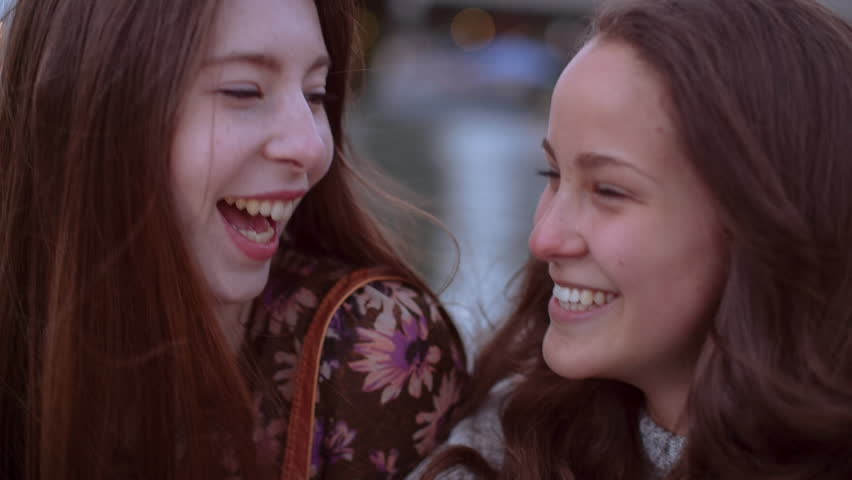 Time lapse shot of happy friends talking while sitting by Willamette River during sunset