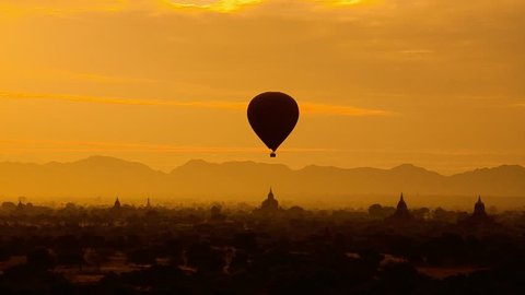 Hot air balloons over ancient Gawdawpalin pagoda of Bagan at dawn, Myanmar