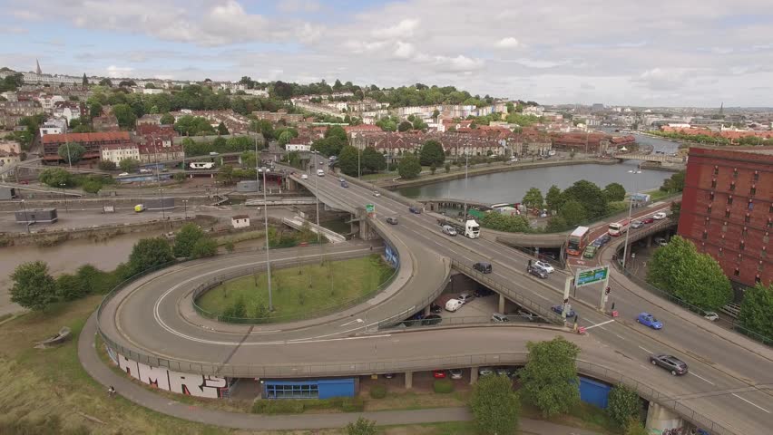 Aerial view of Bristol harbourside, river avon and cars driving on overpass
