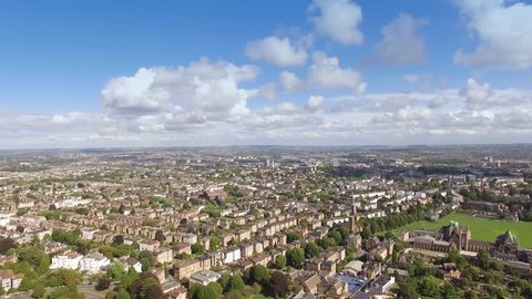 Aerial flyover green tree lined city streets of Bristol, England, drone shot