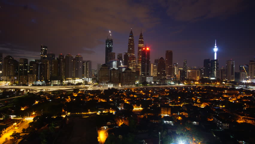 KUALA LUMPUR, MALAYSIA - 16 AUGUST, 2018 : Time lapse of Kuala Lumpur city during daylight, sunset or sunrise. Looking over of Petronas Twin Towers and high building surrounds. | Shutterstock HD Video #1015145950