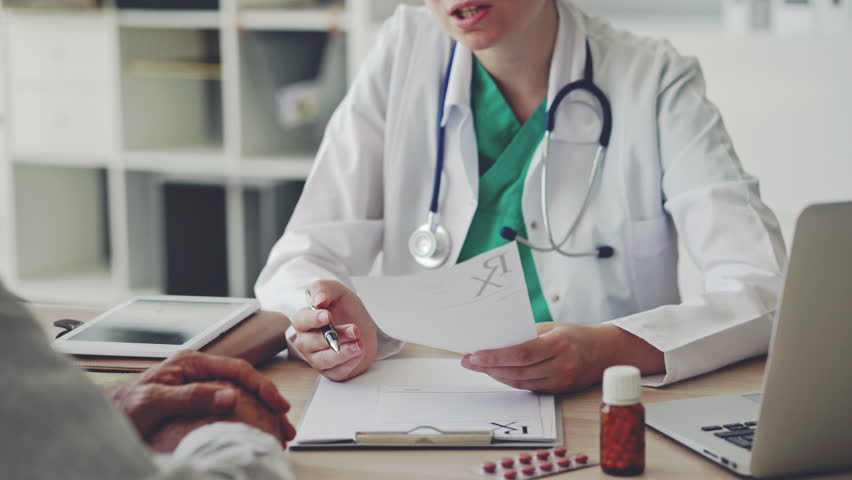 Doctor giving prescription to patient | Shutterstock HD Video #1015147105