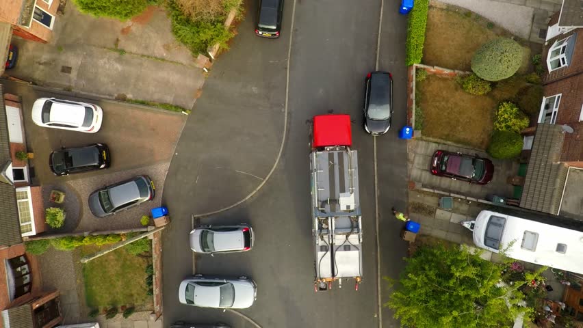 Aerial View, footage of Dustmen putting recycling waste into a garbage truck, Bin men, refuse collectors. bin lorry, Recycling day, Video No1 of 8 Royalty-Free Stock Footage #1015148479