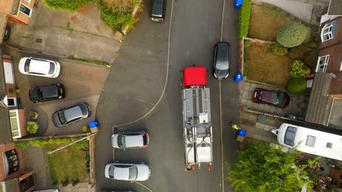 Aerial View, footage of Dustmen putting recycling waste into a garbage truck, Bin men, refuse collectors. bin lorry, Recycling day, Video No1 of 8