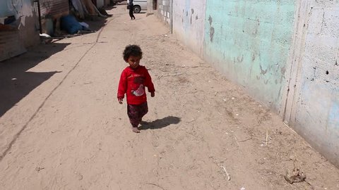 Gaza. Palestinian Territories. May 9, 2018. A young child walks along the road in the bedouin section of Gaza City. 