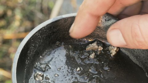 Panning for gold nugget closeup