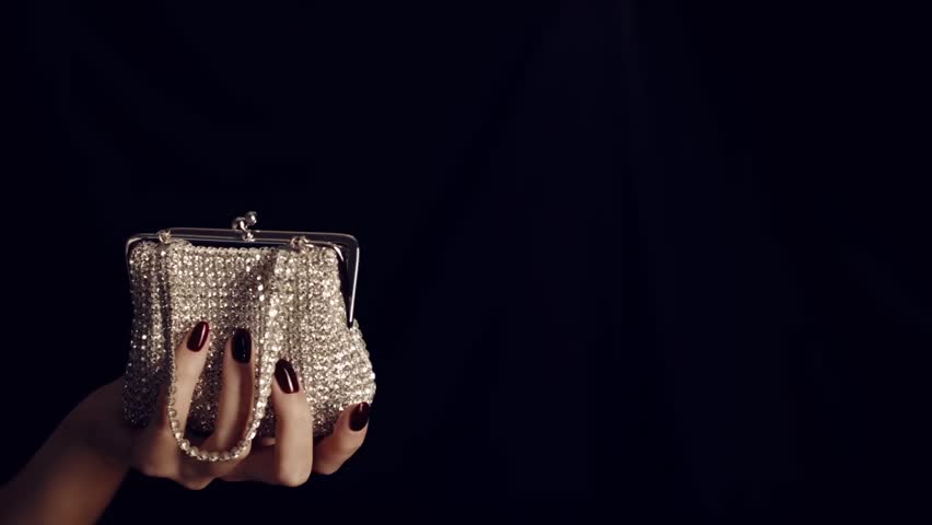 Woman hand holding vintage elegance-handbag decorated  with diamond isolated on black background. Handbag made of diamonds. Female sparkling glamour luxury silver diamond purse handbag. Royalty-Free Stock Footage #1015164112