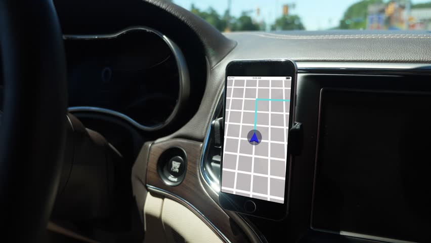 A smartphone attached to the dash on a vent holder in a moving car shows a ride sharing app with route in progress. App screen simulated.	 	 Royalty-Free Stock Footage #1015169206