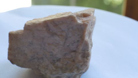 View of geological Orthoclase mineral sample. Orthoclase, or orthoclase feldspar  is an important tectosilicate mineral which forms igneous rock.