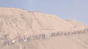 Tourists trekking an active volcano surrounded by mist at sunrise a time-lapse video clip, Bromo, Indonesia