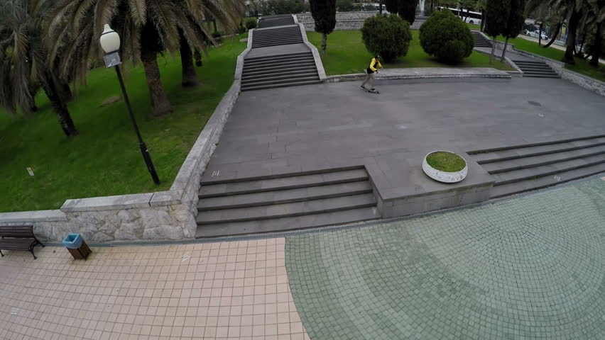 Skateboarder rolls to the fence and stops slow motion