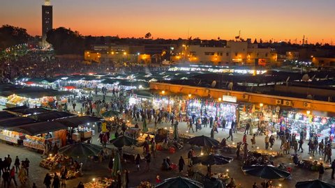Jamaa el Fna (Jemaa el-Fnaa) in the evening. Marrakesh, Morocco. Zoom out shot