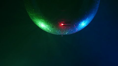 3D Disco mirror ball reflecting colorful lights in smoke