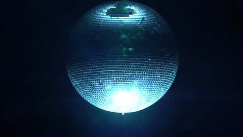 3D Disco mirror ball reflecting colorful lights in smoke on black background
