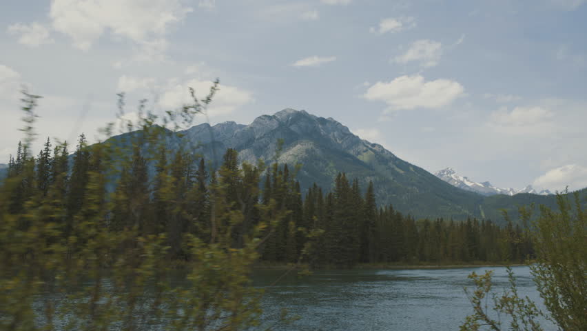 4K Banff, Alberta, Canada - Bow River and mountains - daytime wide angle moving shot