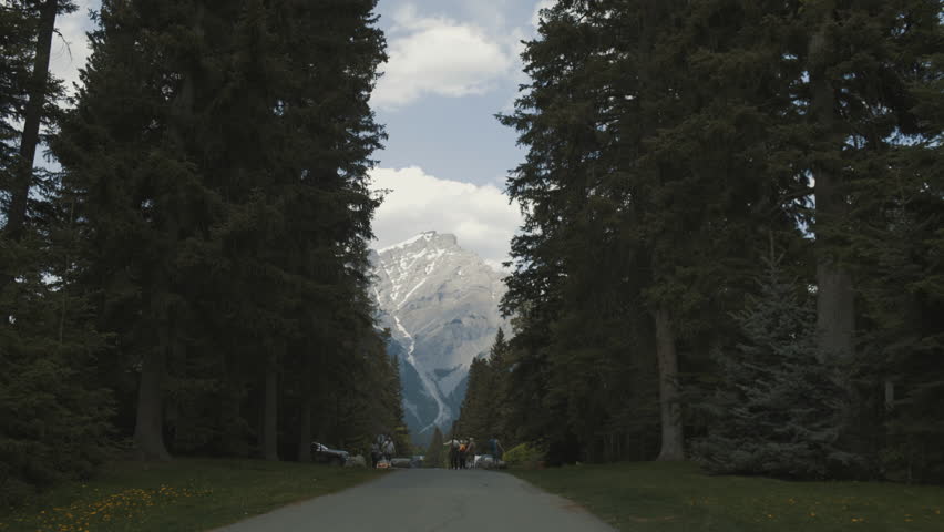 4K Mountain in Banff, Alberta, Canada Framed by Evergreens - daytime wide angle moving shot